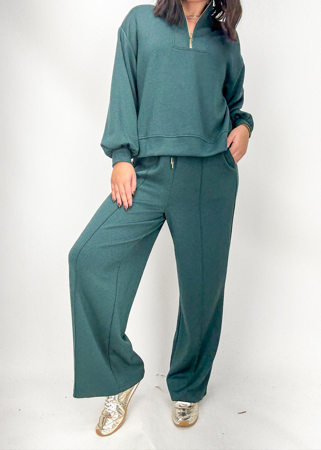 Person wearing a teal tracksuit