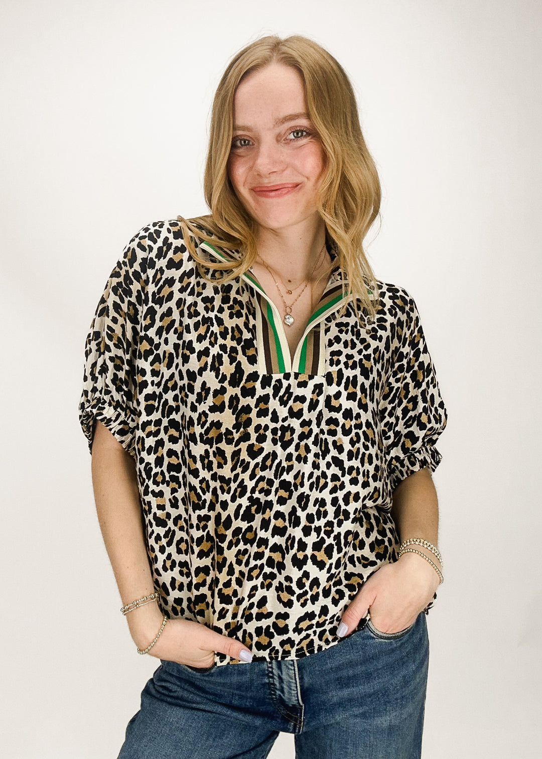 woman wearing leopard print puff sleeve top with stripe collar trim accent