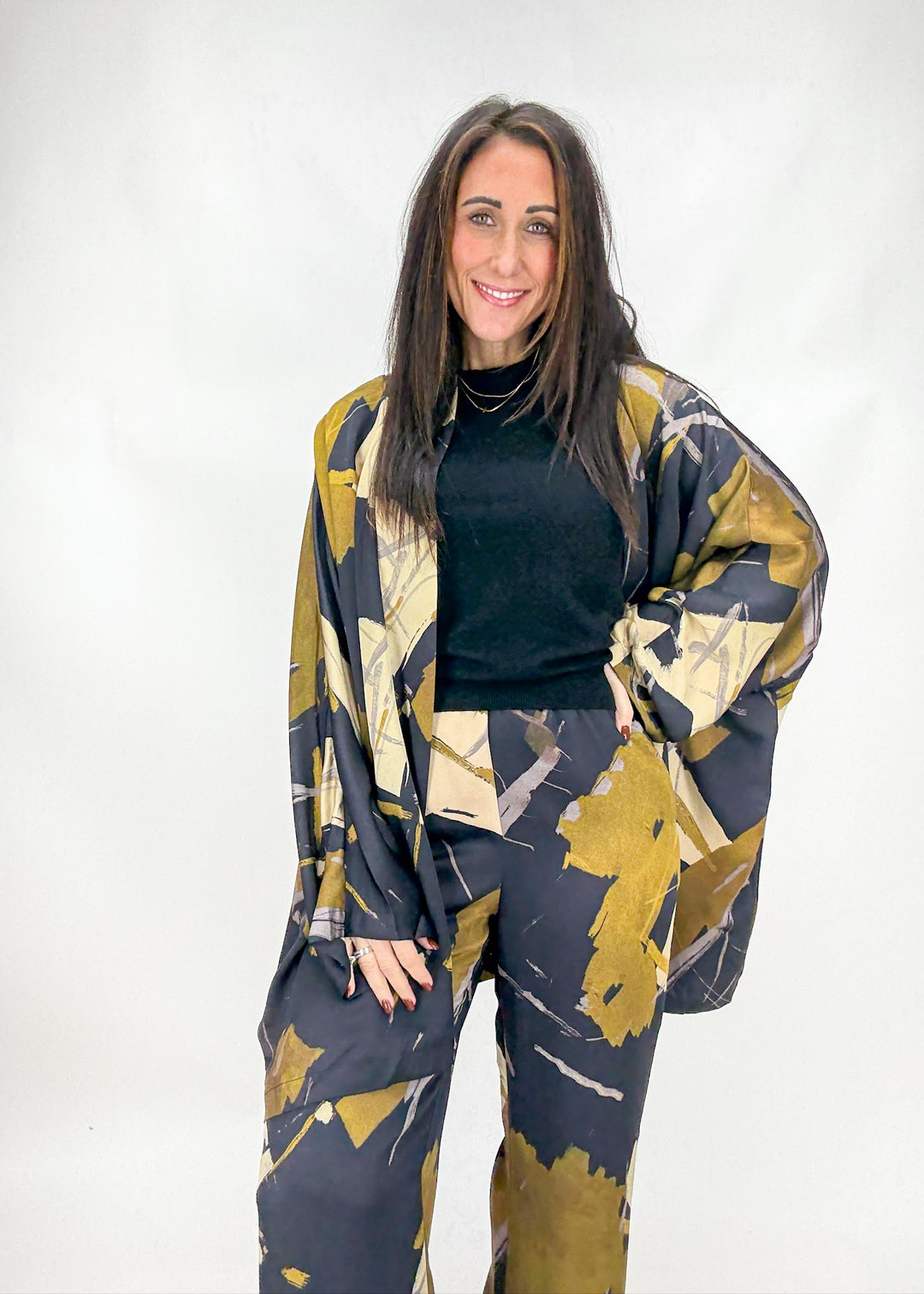 Woman wearing a patterned outfit with a white background