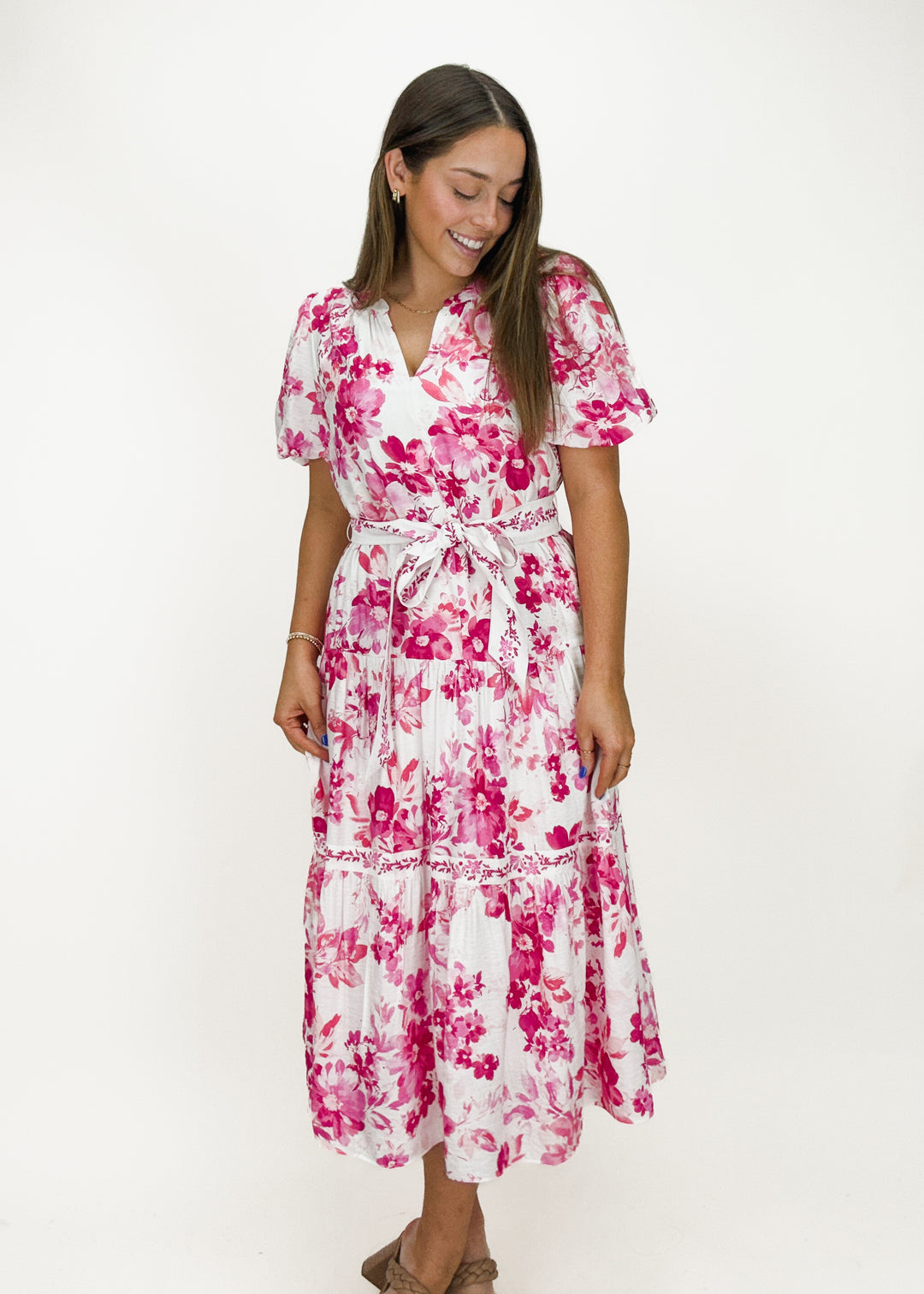 pink and white floral split neck midi dress with puff sleeves, tiered skirt, and tie belt