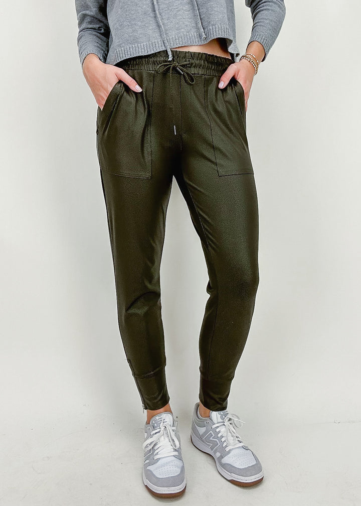 olive green coated jogger sweatpants with ankle zippers and drawstring waist