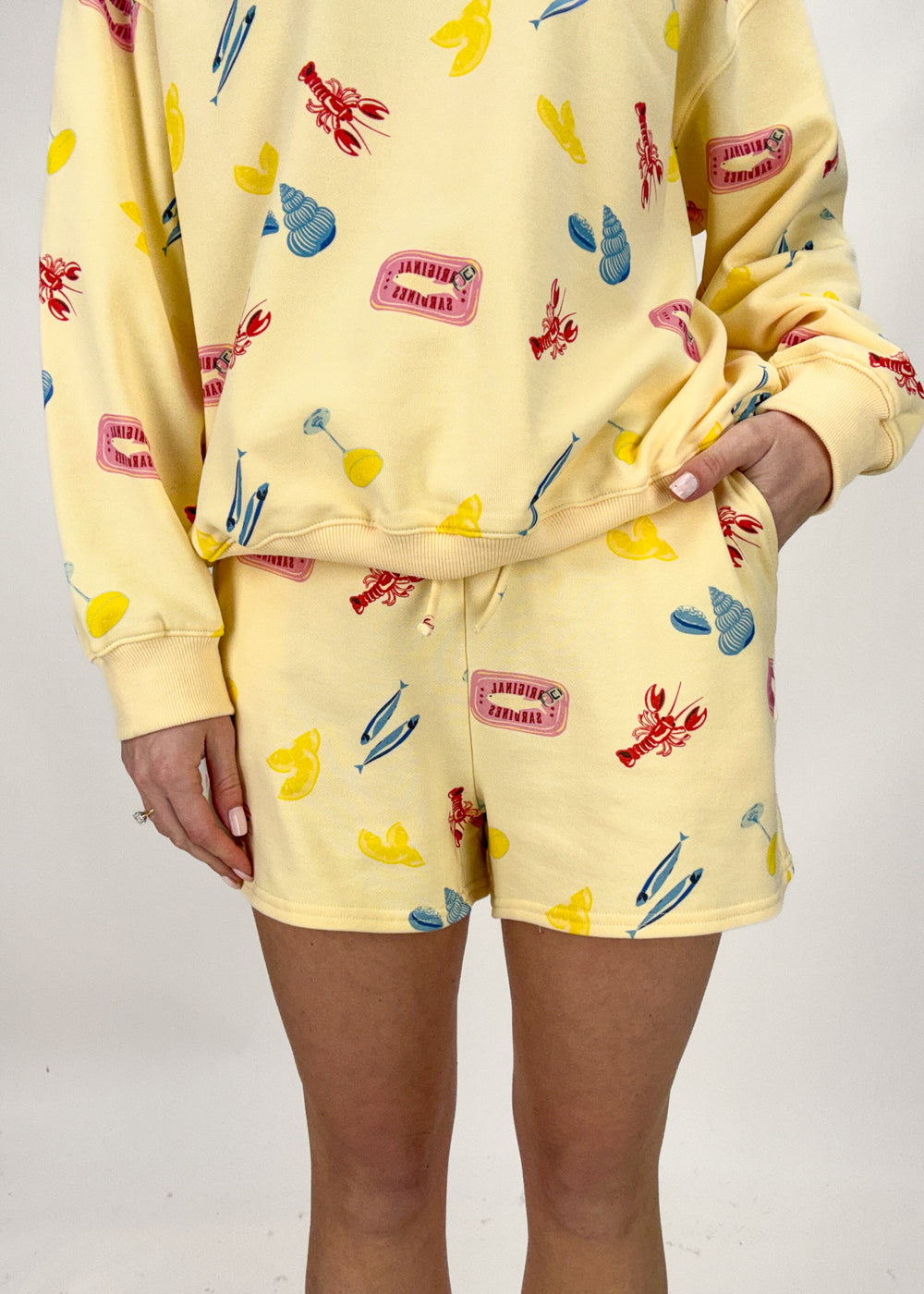 Person wearing a yellow pajama set with colorful patterns on a plain background