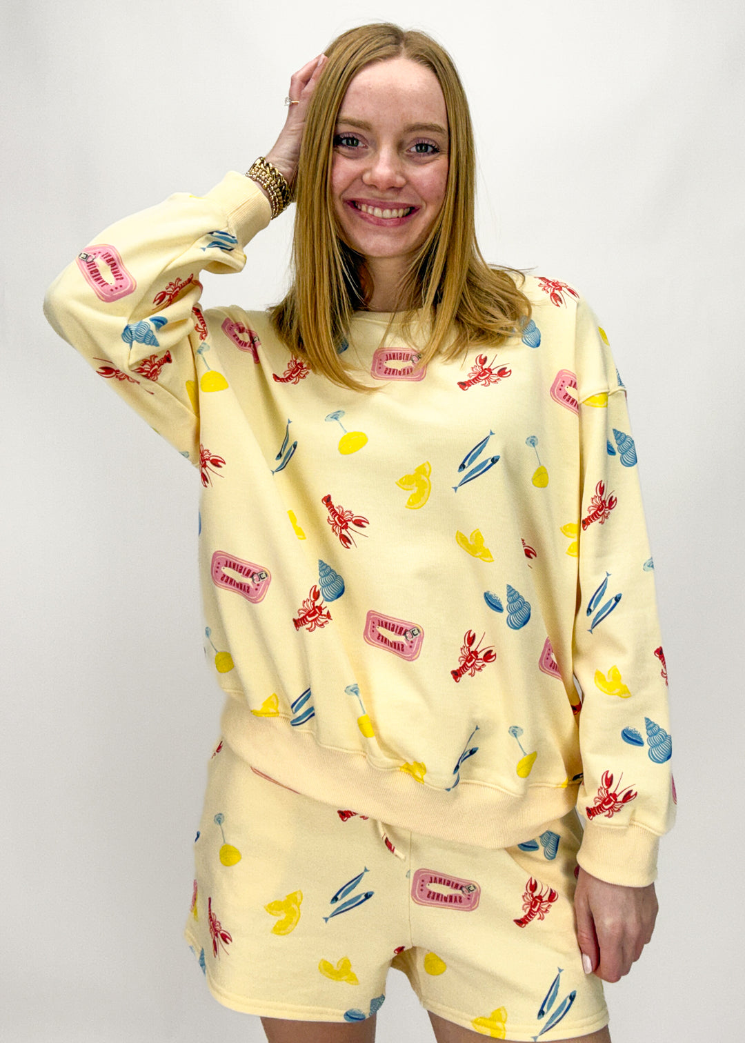 Person wearing a yellow outfit with colorful patterns on a white background