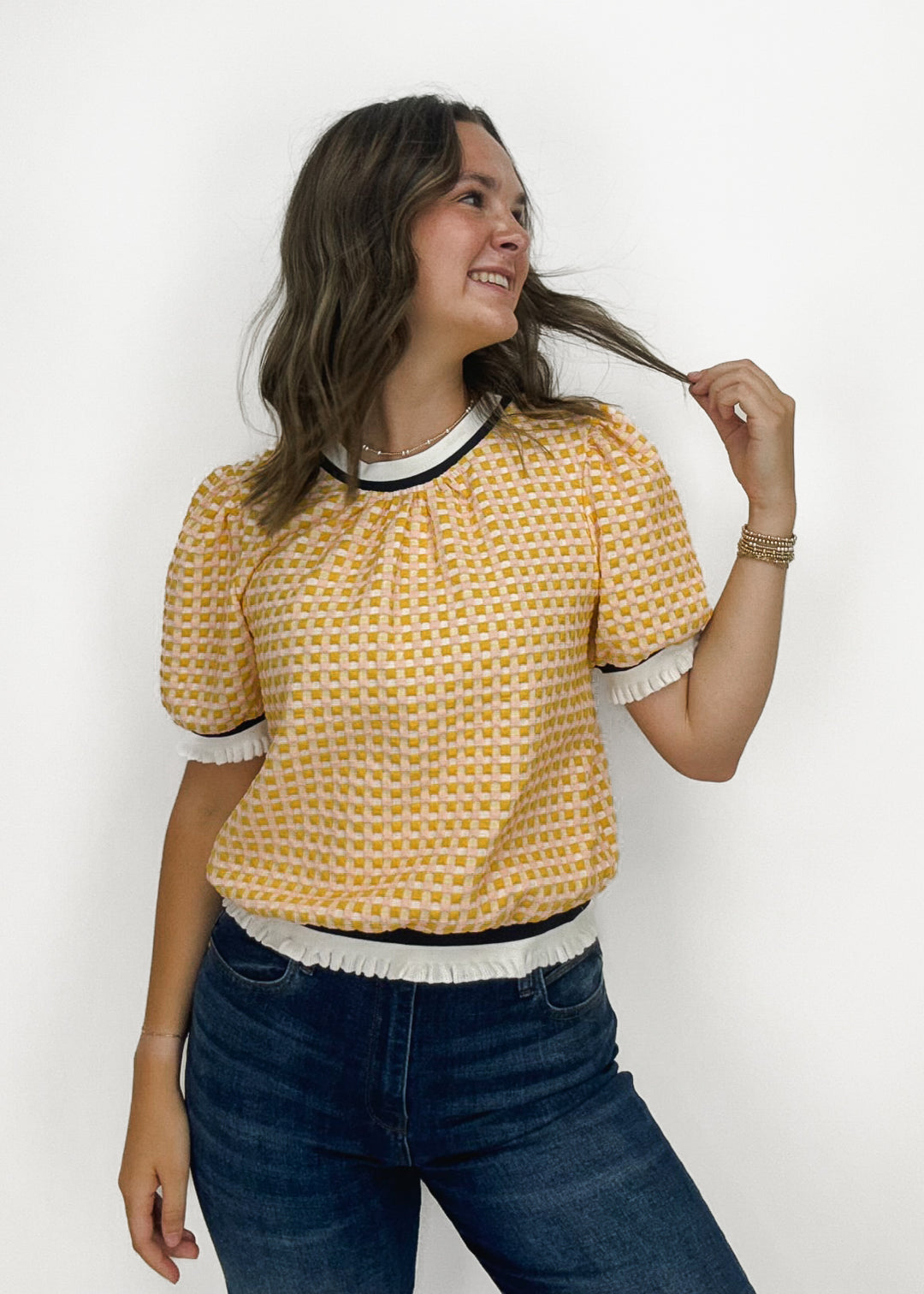 yellow, pink, and white puff sleeve gingham blouse with varsity stripe hem details