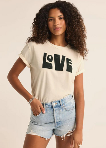 cream tan short sleeve top with black abstract block letters that read "love"